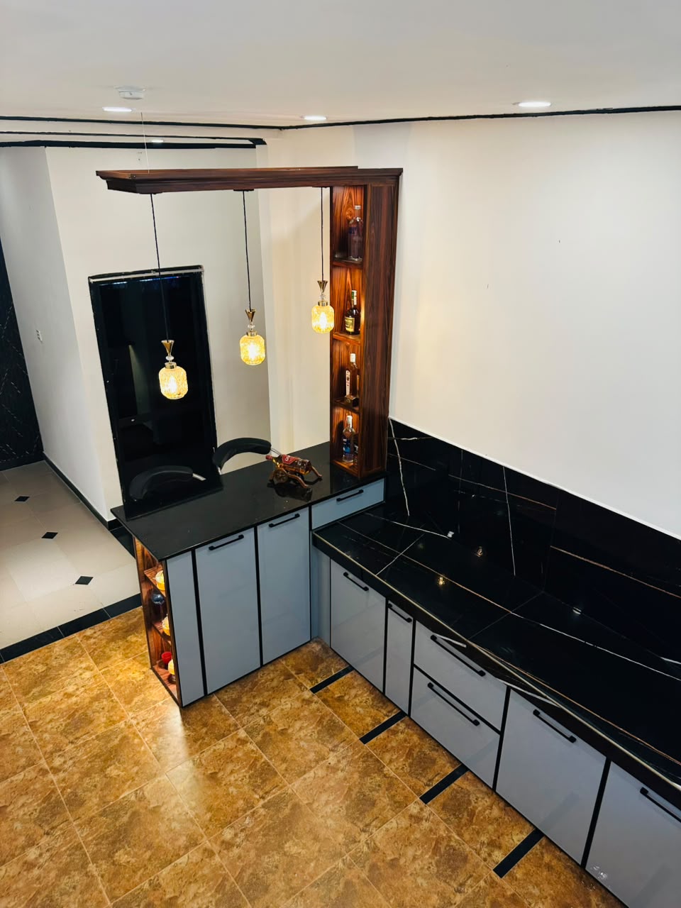 Black and grey bar counter kitchen with wooden display shelves